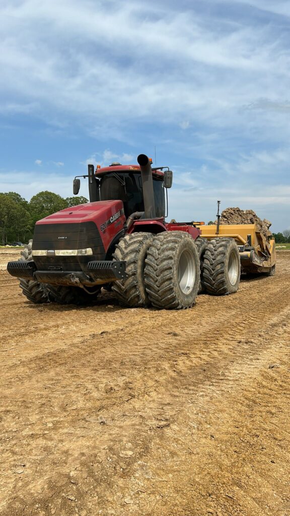 case tractor in an open field with a scraper