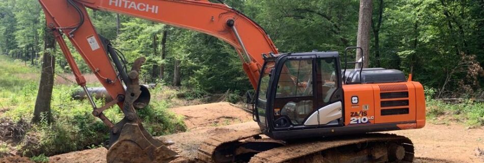 excavator in the woods,